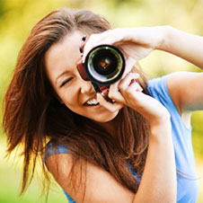 Image of a woman taking a photo.